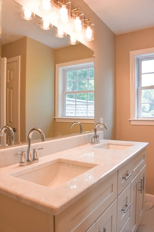 bathroom with a healthy amount of sunlight, tile patterned flooring, and double vanity