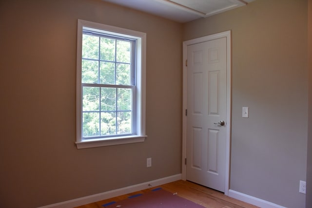 empty room featuring plenty of natural light and wood-type flooring