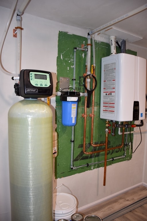 utility room featuring water heater