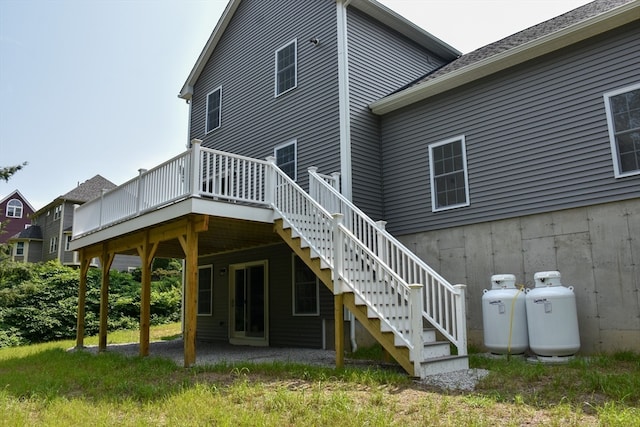 rear view of property featuring a wooden deck