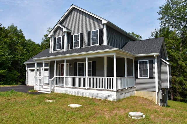 country-style home with a garage, a porch, and a front lawn