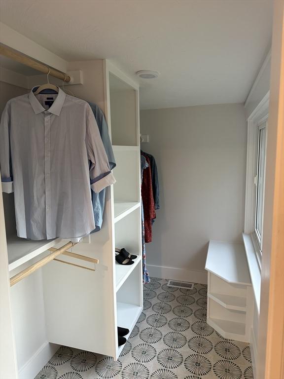 spacious closet featuring visible vents