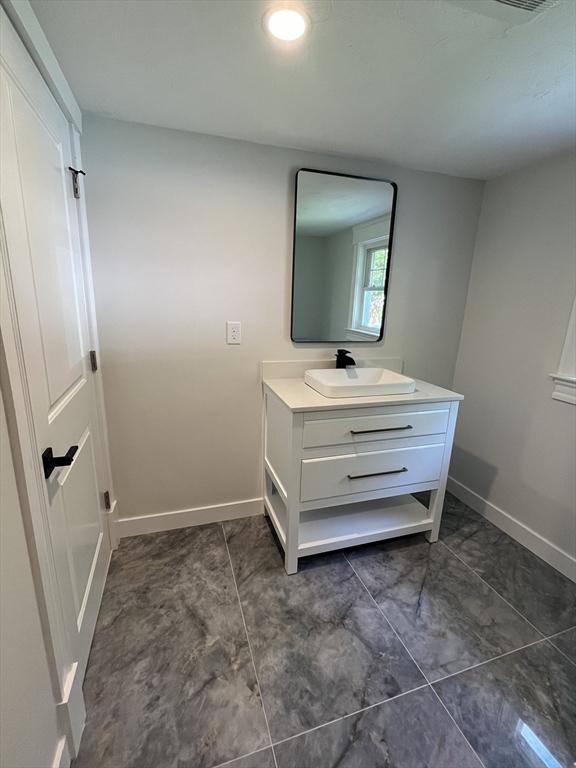 bathroom with baseboards and vanity