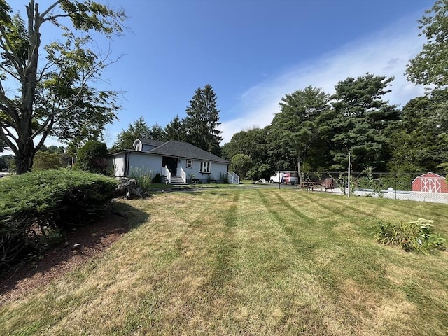 view of yard with entry steps and fence