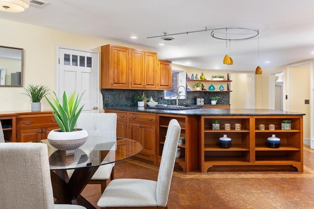 kitchen featuring recessed lighting, decorative backsplash, brown cabinets, open shelves, and dark countertops