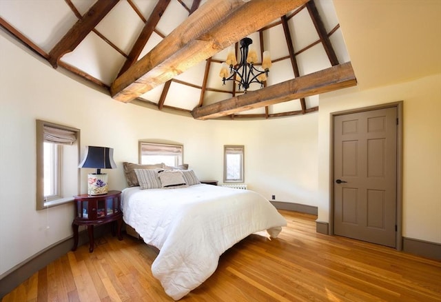 bedroom with high vaulted ceiling, a notable chandelier, wood finished floors, baseboards, and beamed ceiling