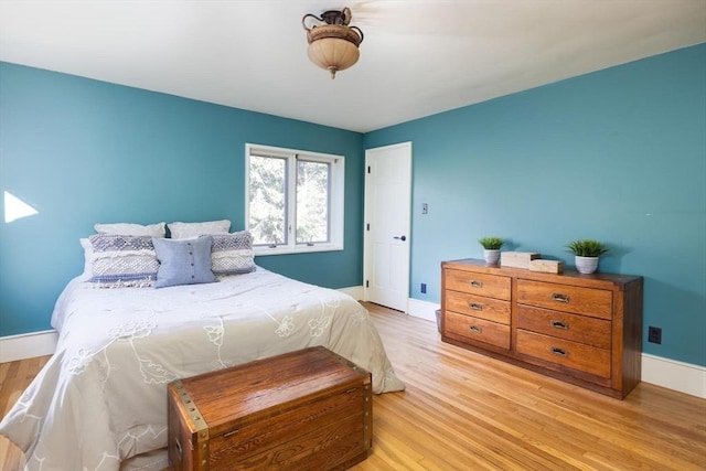 bedroom featuring light wood-type flooring and baseboards