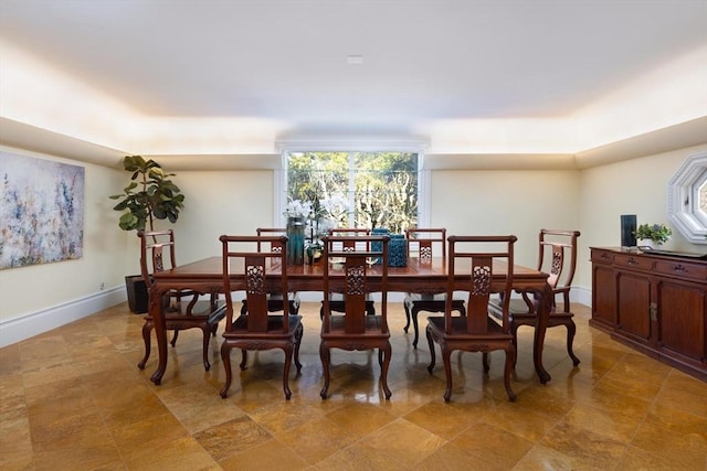 dining space featuring a healthy amount of sunlight and baseboards