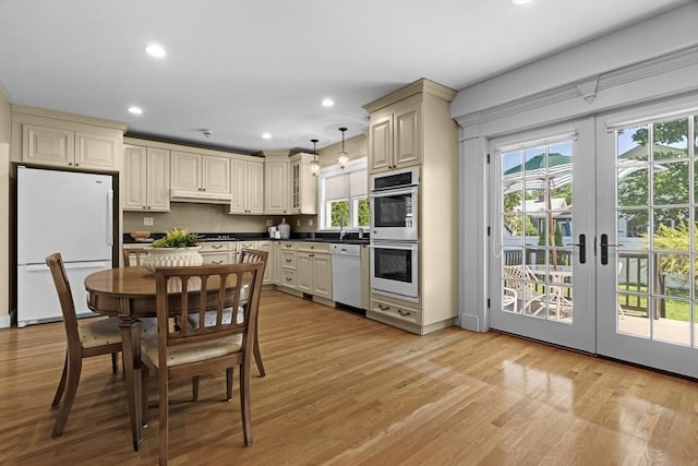 61 Colonial Dr, Arlington, MA 02474 - kitchen with white appliances, cream cabinets, light wood-type flooring, recessed lighting, and french doors