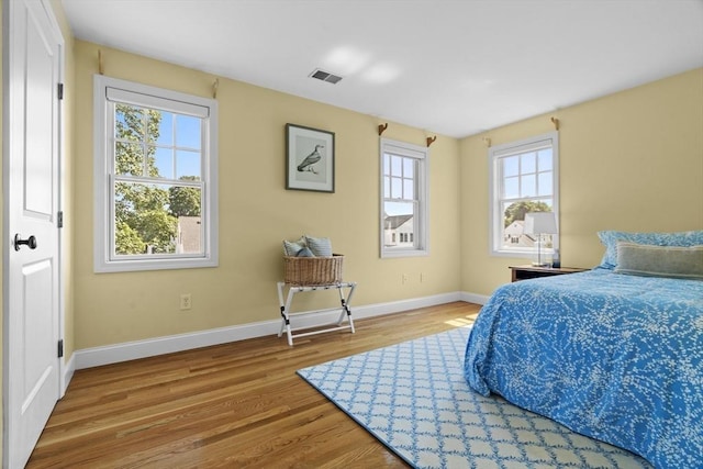 61 Colonial Dr, Arlington, MA 02474 - bedroom featuring multiple windows and wood finished floors