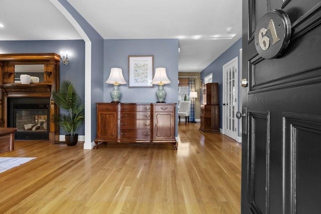 61 Colonial Dr, Arlington, MA 02474 - foyer entrance featuring wood finished floors, arched walkways, and a multi sided fireplace