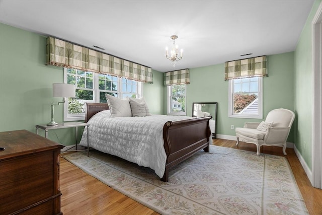 61 Colonial Dr, Arlington, MA 02474 - bedroom with a chandelier and light wood-style floors