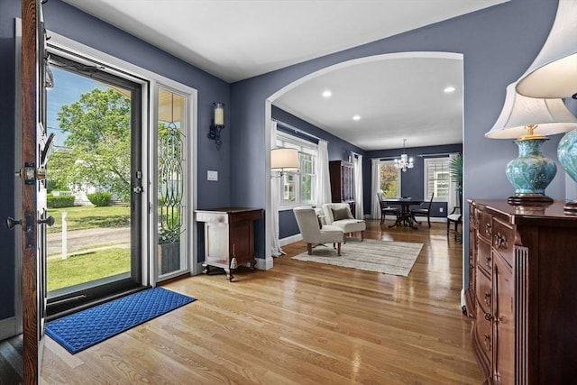 61 Colonial Dr, Arlington, MA 02474 - foyer entrance featuring arched walkways, wood finished floors, a chandelier, and recessed lighting