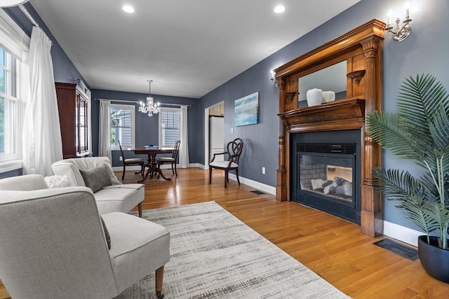61 Colonial Dr, Arlington, MA 02474 - living area with a chandelier, wood finished floors, a multi sided fireplace, and recessed lighting