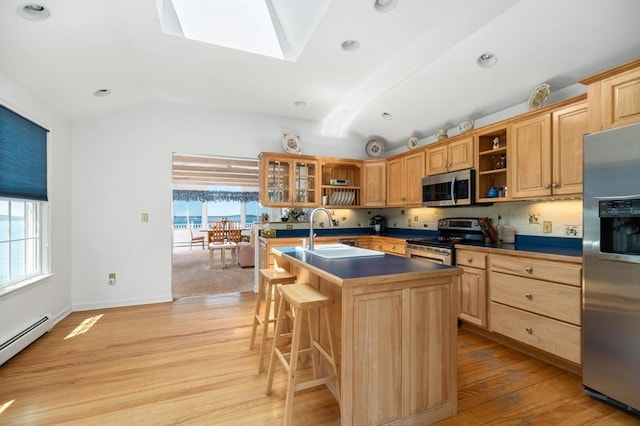 kitchen featuring open shelves, appliances with stainless steel finishes, a healthy amount of sunlight, and lofted ceiling with skylight