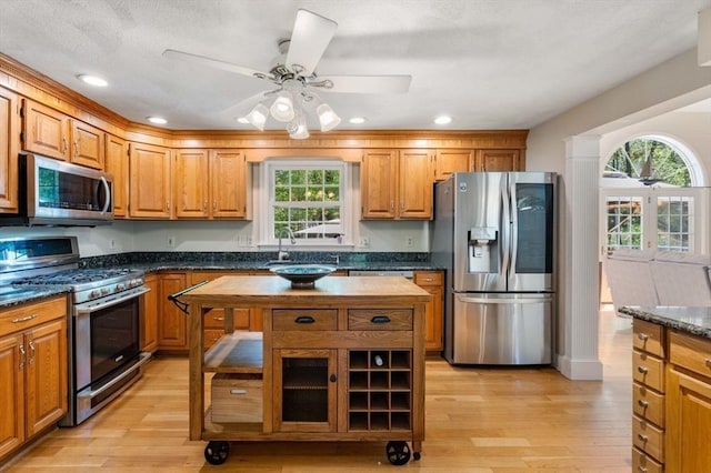 13 Lisa Ln, Georgetown, MA 01833 - kitchen featuring stainless steel appliances, healthy amount of natural light, brown cabinets, light wood-type flooring, and recessed lighting