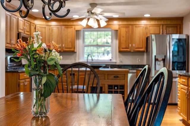 13 Lisa Ln, Georgetown, MA 01833 - kitchen with stainless steel fridge with ice dispenser, dark countertops, ceiling fan, recessed lighting, and brown cabinetry