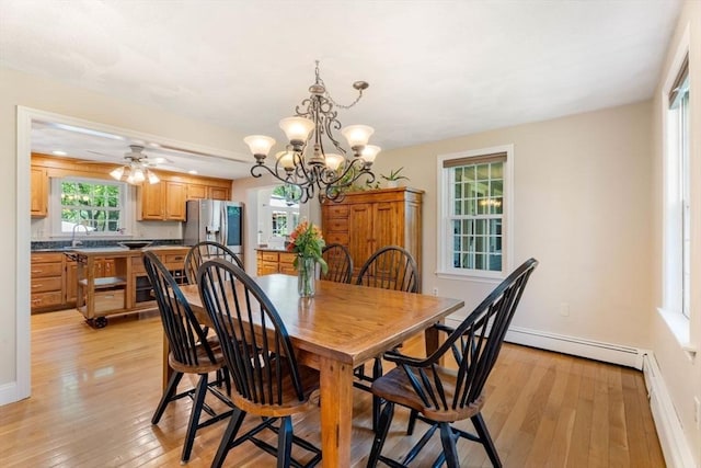13 Lisa Ln, Georgetown, MA 01833 - dining room with light wood-type flooring, baseboard heating, baseboards, and a chandelier