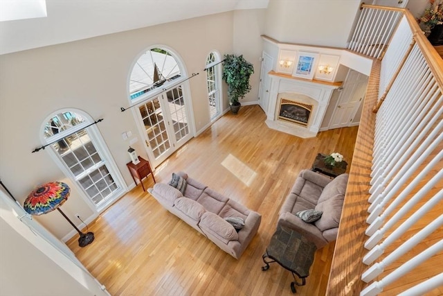 13 Lisa Ln, Georgetown, MA 01833 - living area featuring high vaulted ceiling, light wood finished floors, a fireplace, and baseboards