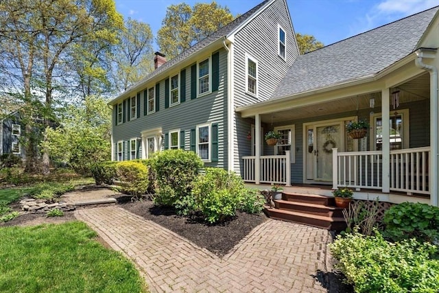 13 Lisa Ln, Georgetown, MA 01833 - view of front of house featuring a chimney, a porch, and a shingled roof