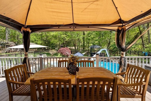 13 Lisa Ln, Georgetown, MA 01833 - wooden terrace featuring a gazebo, outdoor dining area, and an outdoor pool