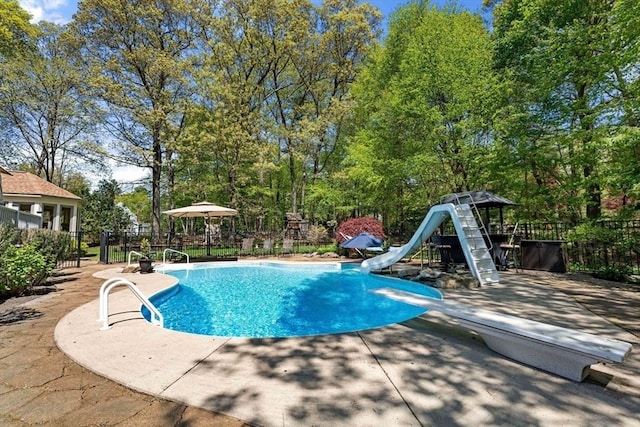 13 Lisa Ln, Georgetown, MA 01833 - view of pool with a water slide, a diving board, a patio area, and view of scattered trees