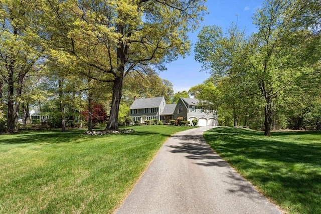13 Lisa Ln, Georgetown, MA 01833 - view of front of house with asphalt driveway, an attached garage, and a front lawn