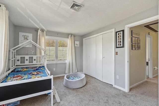 51 Fox Meadow Rd Unit A, Leominster, MA 01453 - bedroom featuring baseboards, carpet flooring, a textured ceiling, and a closet