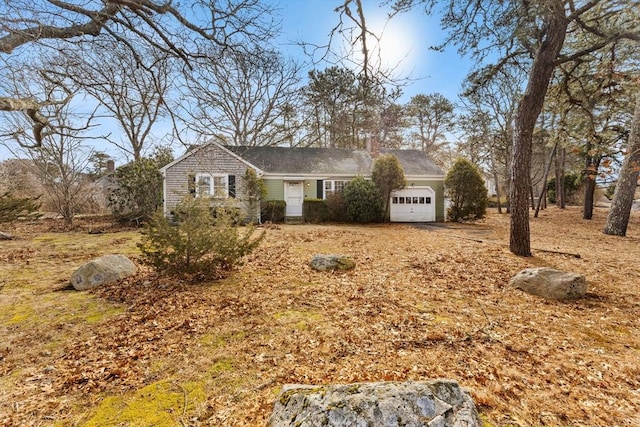 view of front of property featuring a chimney and an attached garage