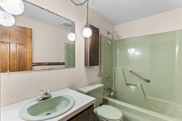 bathroom featuring toilet, vanity, and shower / bathtub combination