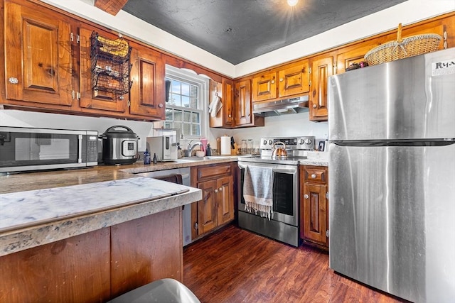 18 Cannongate Rd Unit 68, Tyngsborough, MA 01879 - kitchen with appliances with stainless steel finishes, under cabinet range hood, brown cabinetry, and a sink