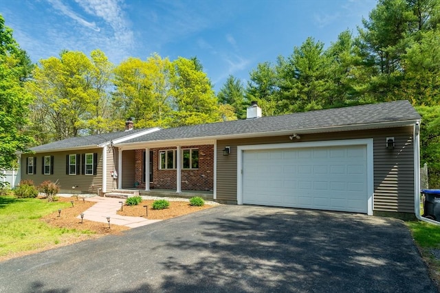 198 Groton St, Dunstable, MA 01827 - ranch-style home with asphalt driveway, an attached garage, a chimney, and covered porch