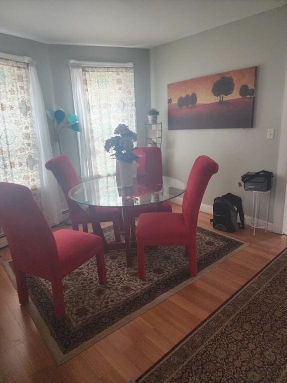 dining room with baseboards and wood finished floors