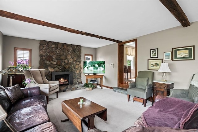 18 E St, Beverly, MA 01915 - carpeted living area featuring beam ceiling, plenty of natural light, a stone fireplace, and baseboards