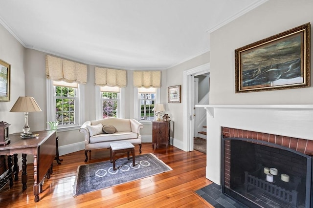 18 E St, Beverly, MA 01915 - living room with hardwood / wood-style flooring, crown molding, baseboards, and a fireplace