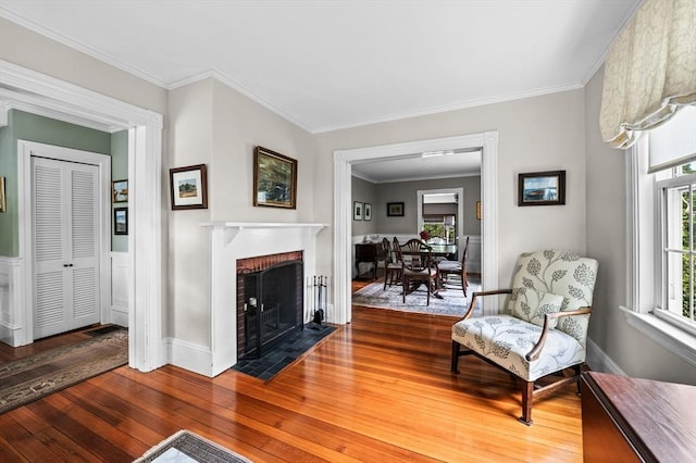 18 E St, Beverly, MA 01915 - living room with wood-type flooring, a fireplace, and crown molding