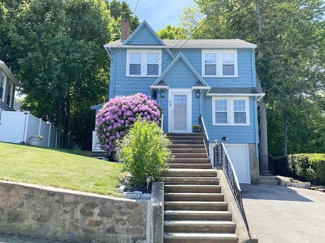 54 Hilltop St, Quincy, MA 02169 - view of front of home featuring asphalt driveway, a chimney, an attached garage, and a shingled roof