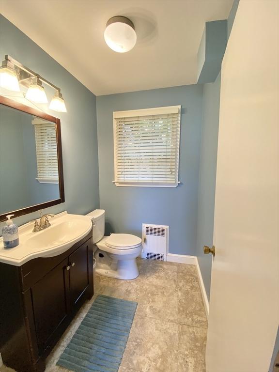 54 Hilltop St, Quincy, MA 02169 - bathroom featuring radiator, toilet, vanity, tile patterned floors, and baseboards