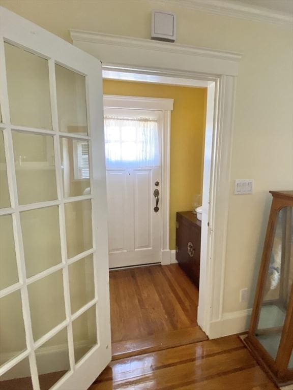 54 Hilltop St, Quincy, MA 02169 - doorway to outside featuring wood finished floors, baseboards, and ornamental molding