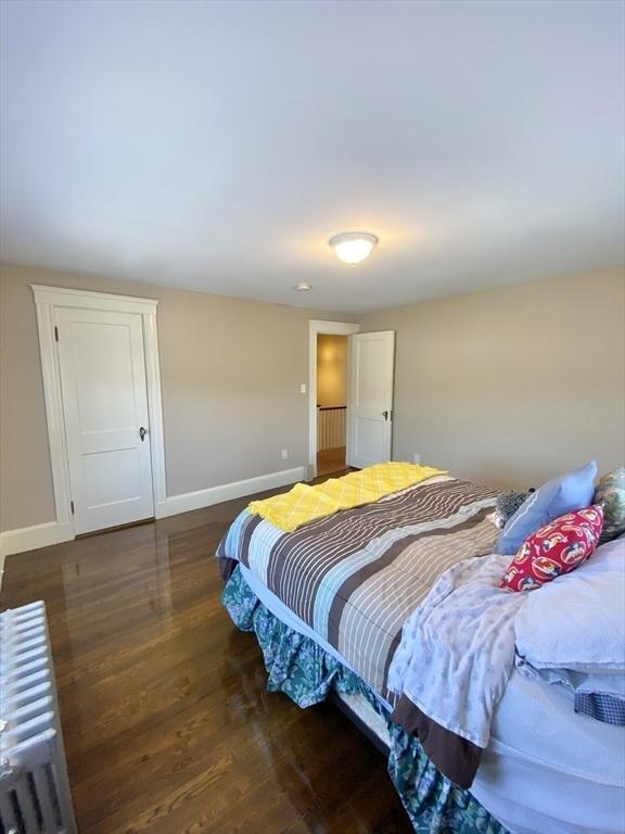 54 Hilltop St, Quincy, MA 02169 - bedroom with radiator heating unit, baseboards, and wood finished floors
