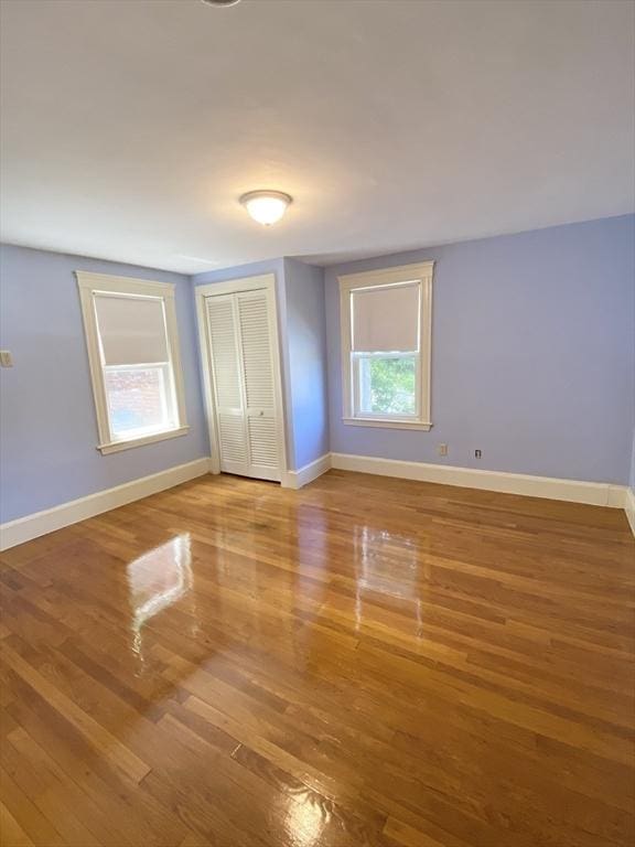 54 Hilltop St, Quincy, MA 02169 - unfurnished bedroom with wood finished floors, baseboards, and a closet