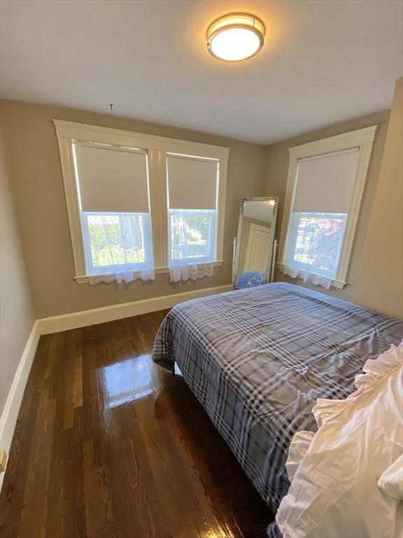 54 Hilltop St, Quincy, MA 02169 - bedroom featuring multiple windows, wood finished floors, and baseboards