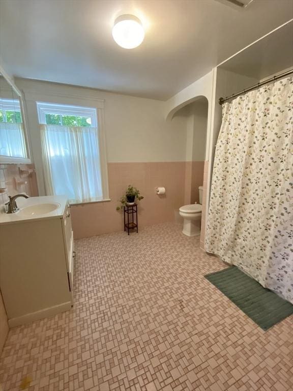 54 Hilltop St, Quincy, MA 02169 - full bath featuring vanity, toilet, wainscoting, a shower with curtain, and tile patterned floors