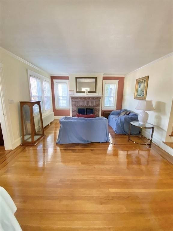 54 Hilltop St, Quincy, MA 02169 - bedroom with ornamental molding, light wood finished floors, a brick fireplace, and baseboards