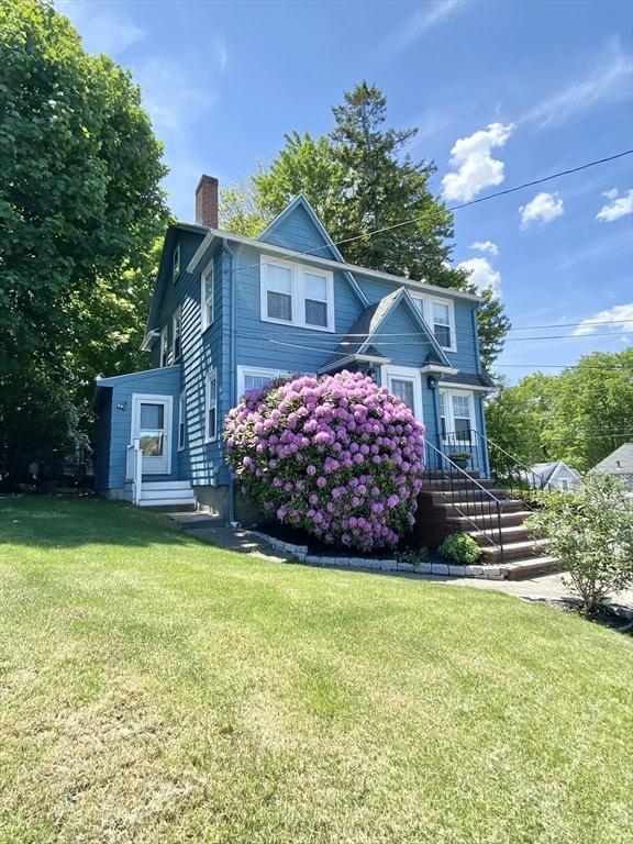 54 Hilltop St, Quincy, MA 02169 - view of front of home with a chimney, a front yard, and entry steps