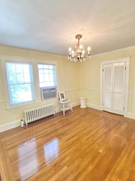 54 Hilltop St, Quincy, MA 02169 - dining area featuring radiator heating unit, a chandelier, wood finished floors, crown molding, and cooling unit