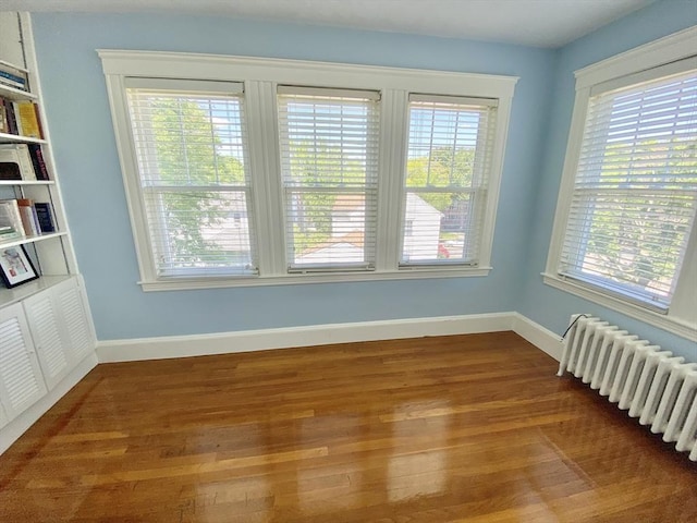 54 Hilltop St, Quincy, MA 02169 - unfurnished room featuring radiator heating unit, wood finished floors, and baseboards