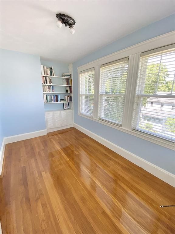 54 Hilltop St, Quincy, MA 02169 - spare room with baseboards, light wood finished floors, and built in features