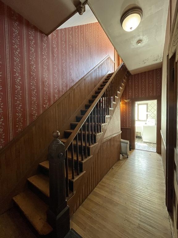 74 Newhall Unit 9, Lynn, MA 01902 - stairs featuring wallpapered walls and wood finished floors
