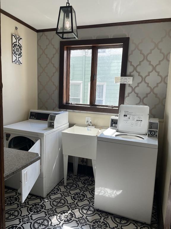 74 Newhall Unit 9, Lynn, MA 01902 - laundry area with washer and clothes dryer, crown molding, wallpapered walls, and plenty of natural light